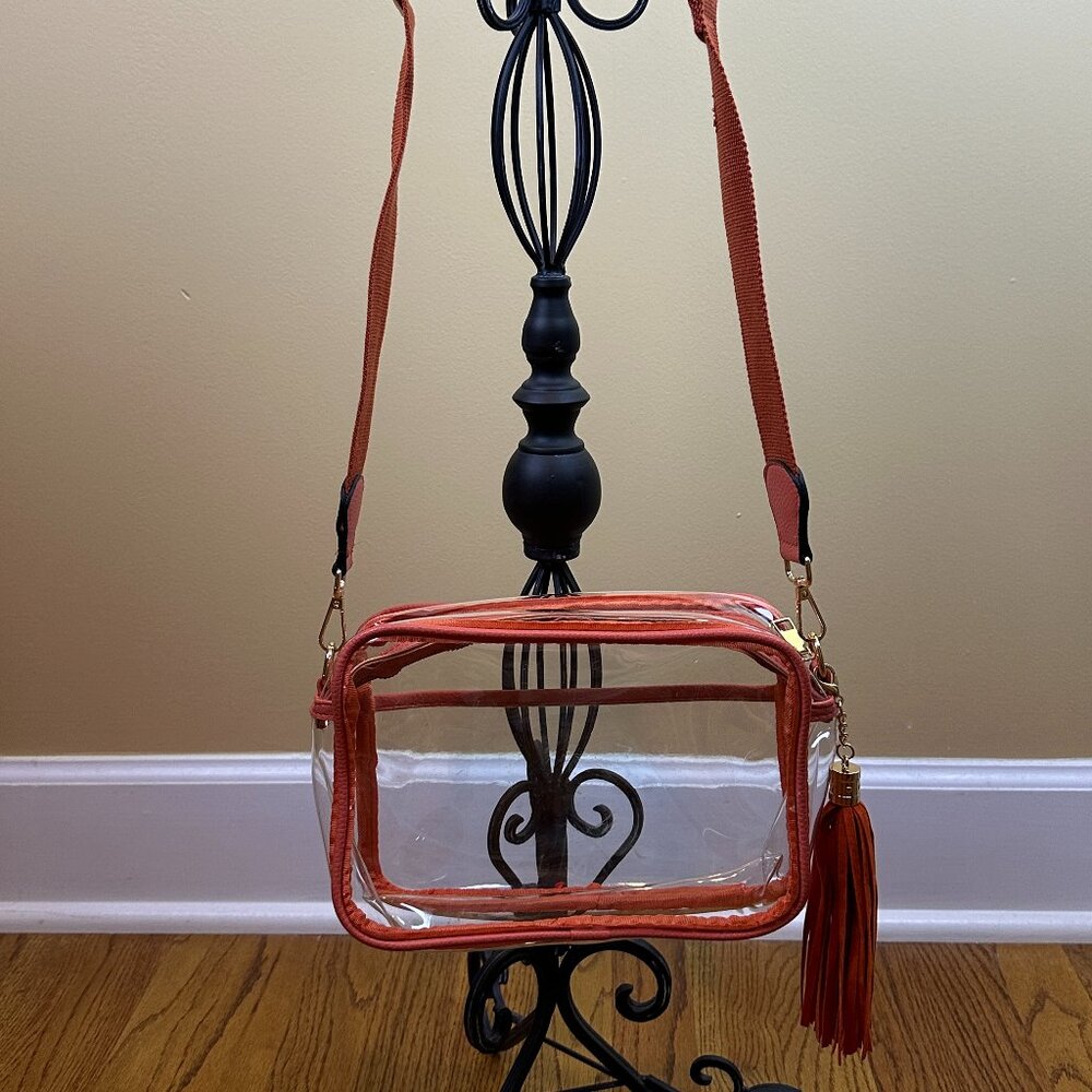 CLEAR cross body purse. Orange trim with gold hardware  Front pocket Stadium bag